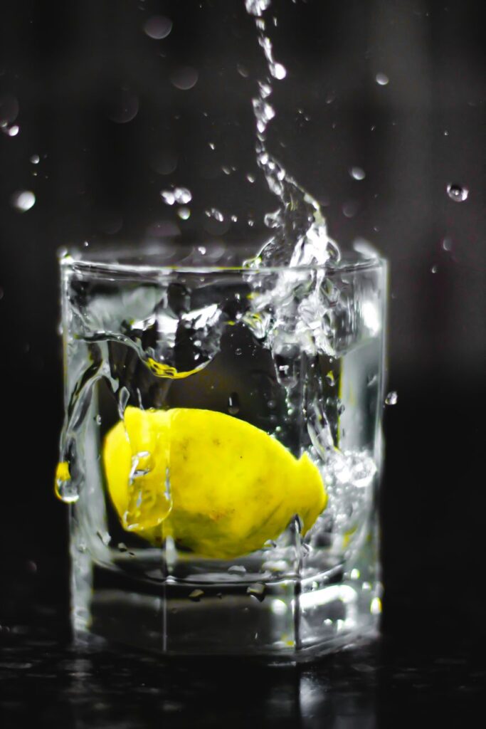 A glass of water with fresh lemon slices